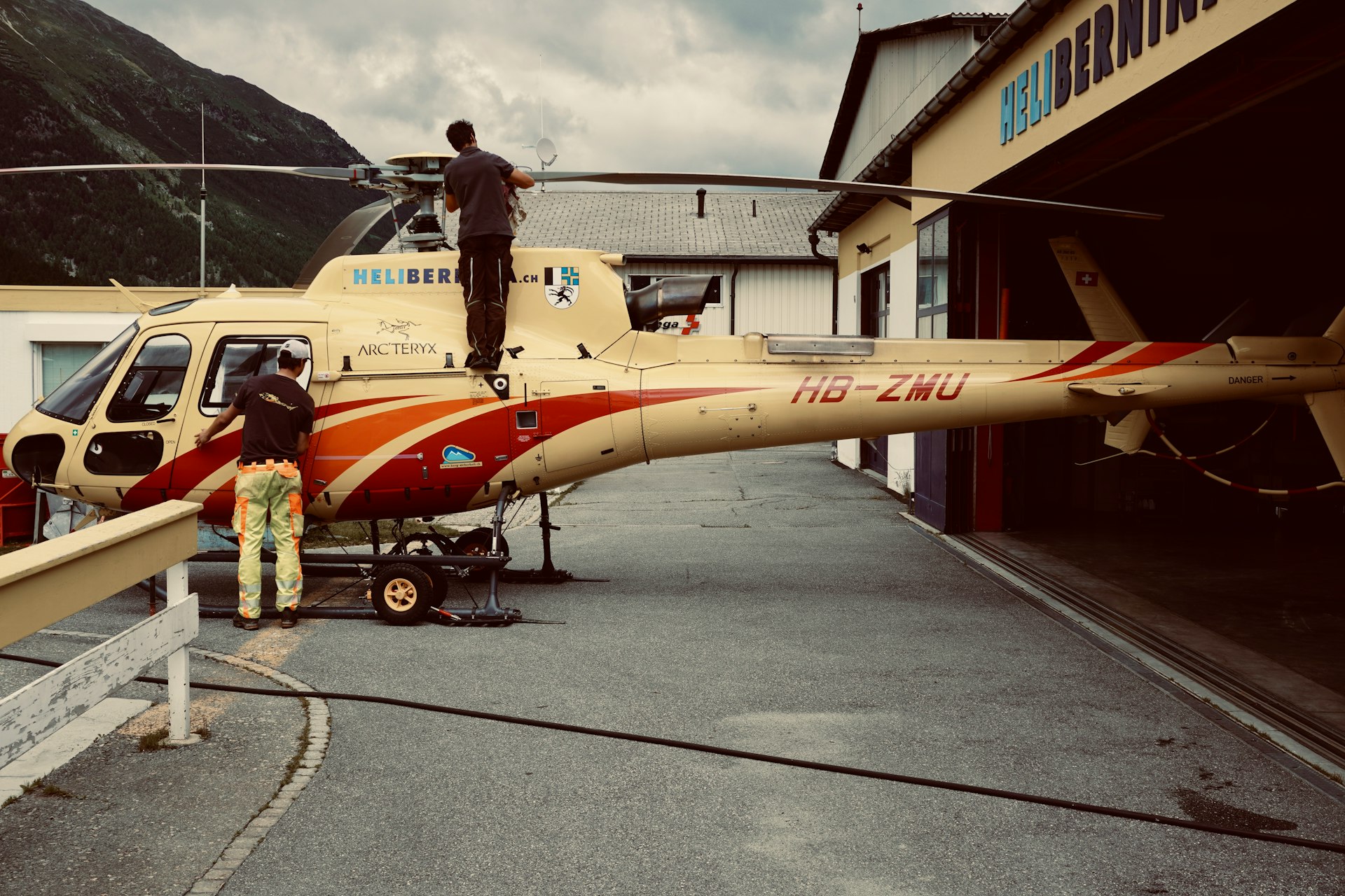 woman in red and white dress standing beside yellow and red airplane during daytime